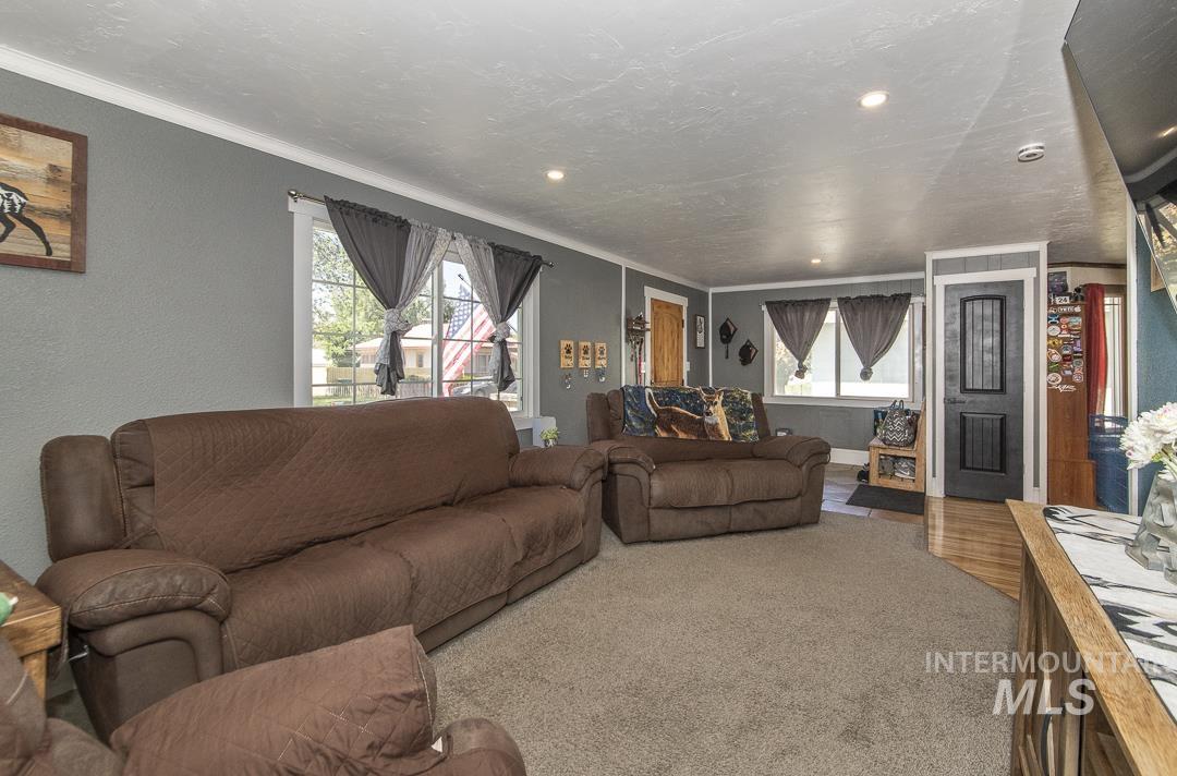 486 West Main Street South Vale, OR 97918 - Photo 6 of 37 Living area with gray wall paint and white crown molding