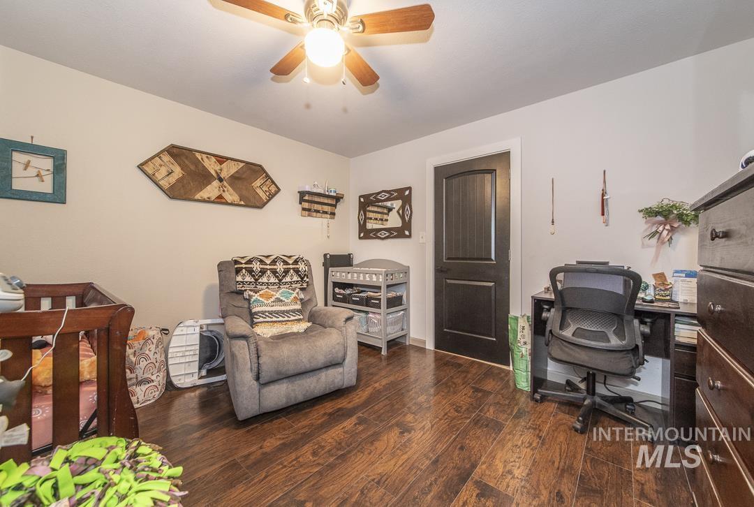 486 West Main Street South Vale, OR 97918 - Photo 7 of 37 Interior room featuring wood-finish flooring, light-toned walls, and a ceiling fan with integrated lighting