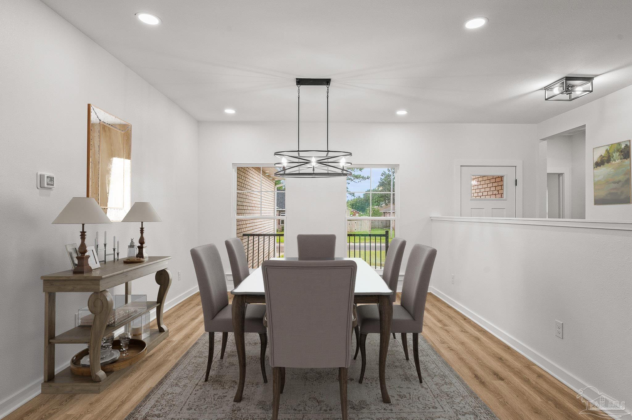 1192 Adrian Way Milton, FL 32583 - Photo 15 of 37 a view of a dining room with furniture window and wooden floor