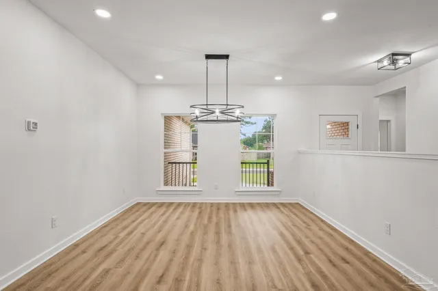 a view of kitchen and dining room with wooden floor