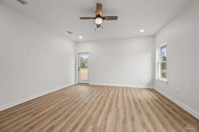 a bathroom with a white tub shower sink and mirror