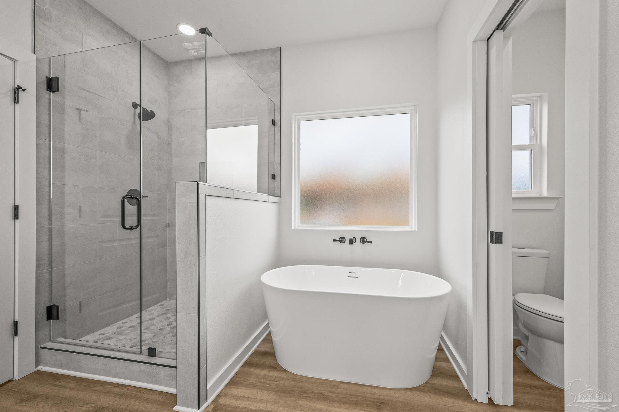 1192 Adrian Way Milton, FL 32583 - Photo 21 of 37 a bathroom with a white tub shower sink and mirror