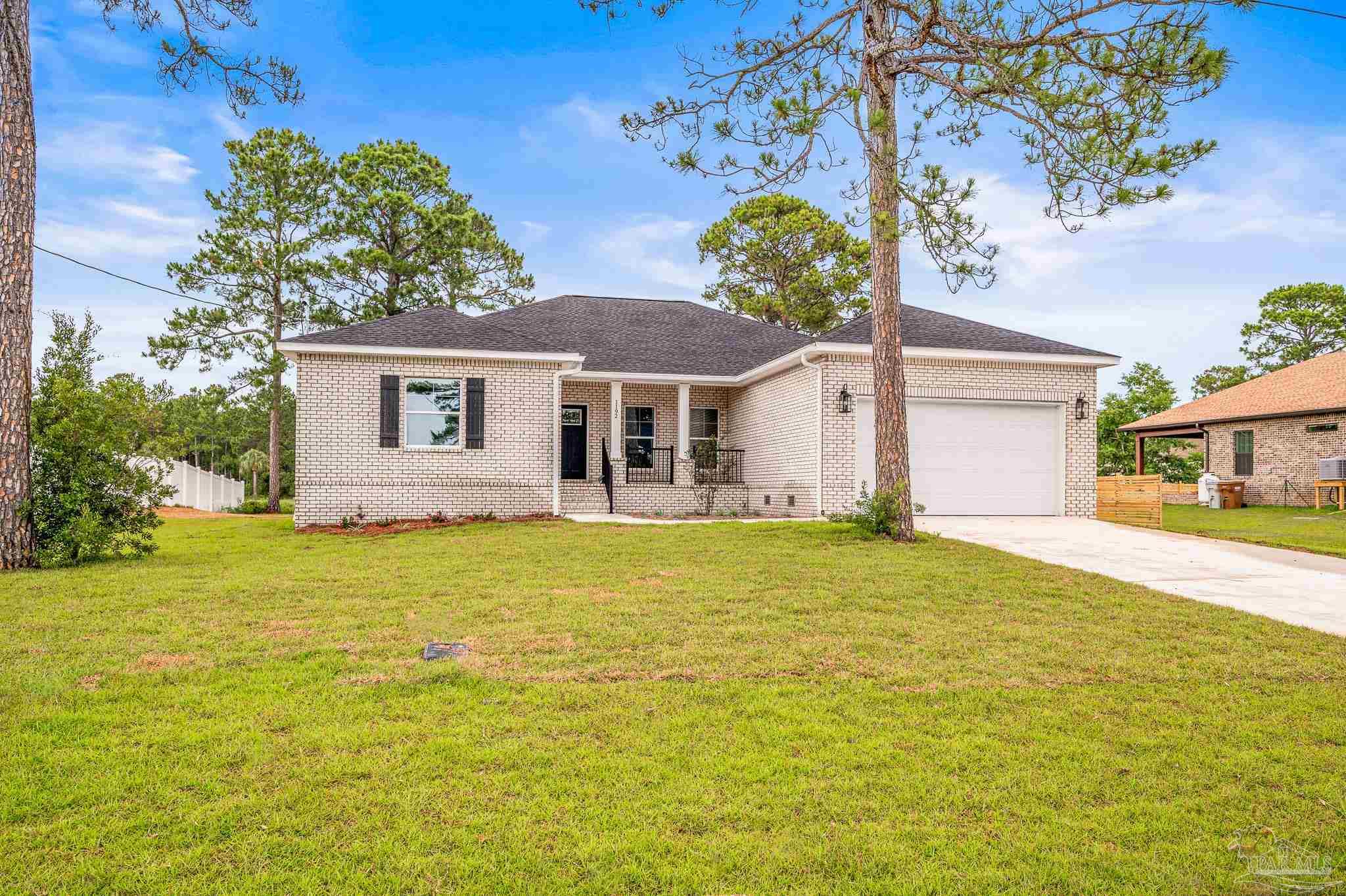 1192 Adrian Way Milton, FL 32583 - Photo 36 of 37 a front view of a house with a garden