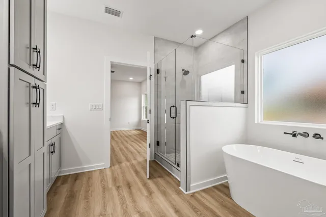 a bathroom with a tub shower and sink