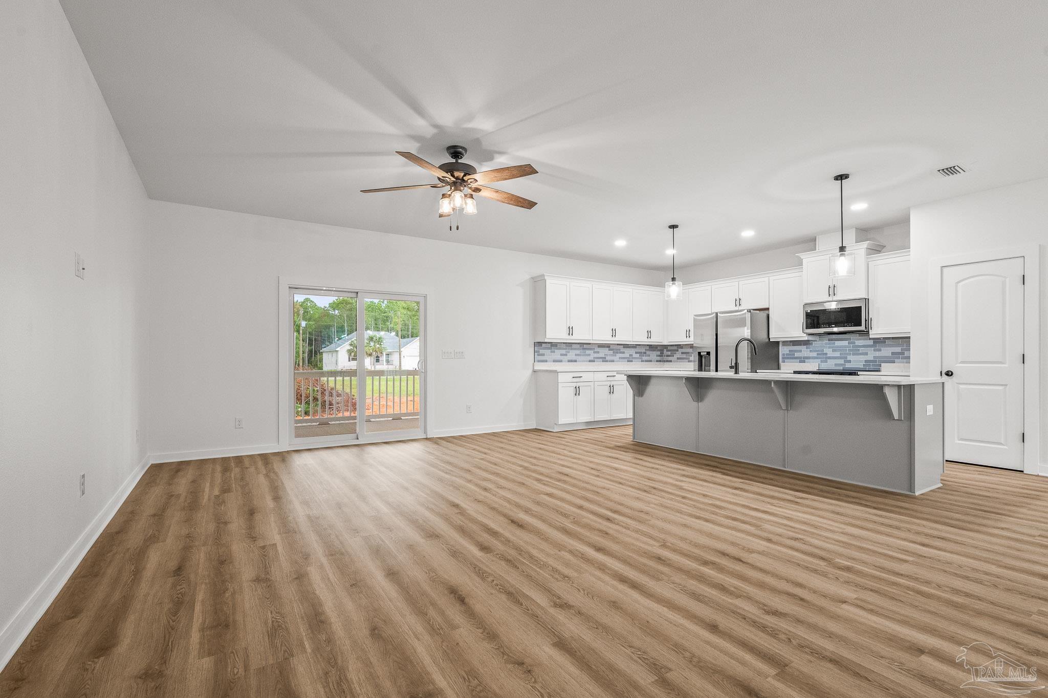 1192 Adrian Way Milton, FL 32583 - Photo 7 of 37 a view of kitchen with wooden floor and window
