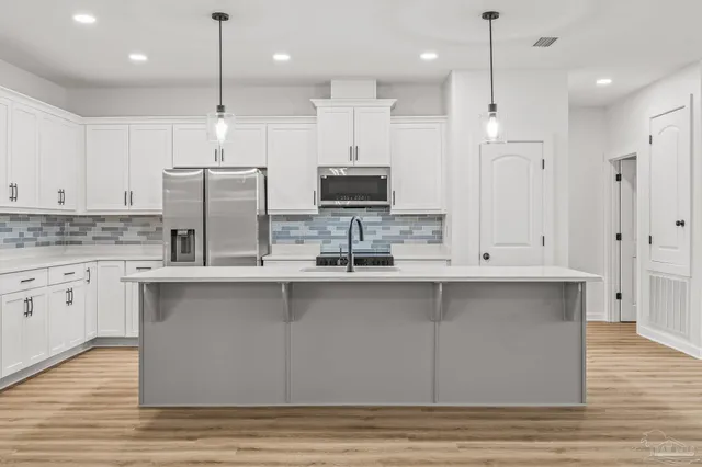 a living room with furniture and kitchen view