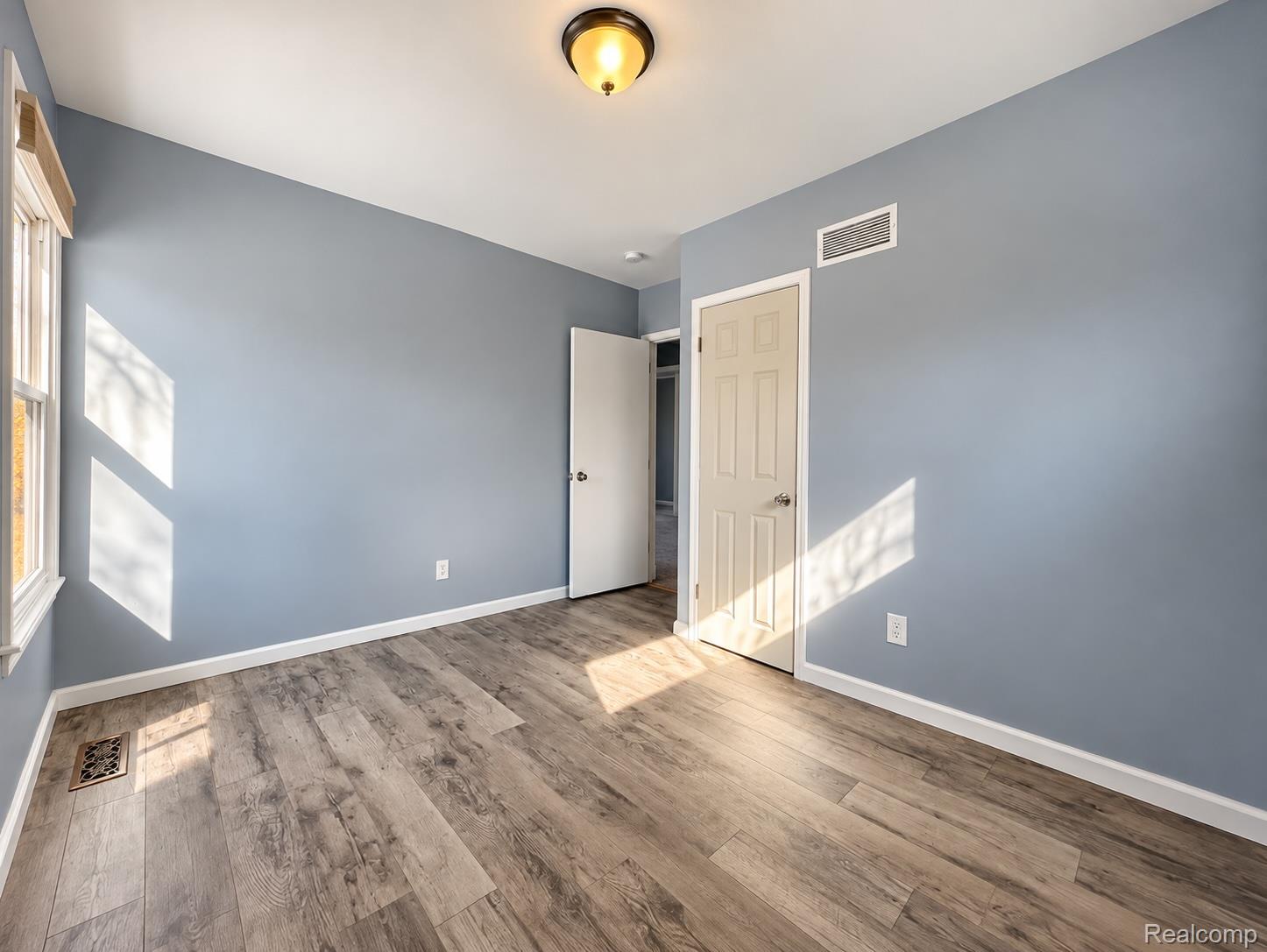21761 Middlebelt Road Farmington, MI 48336 - Photo 16 of 21 Wood-finish flooring with white trim and a neutral wall color
