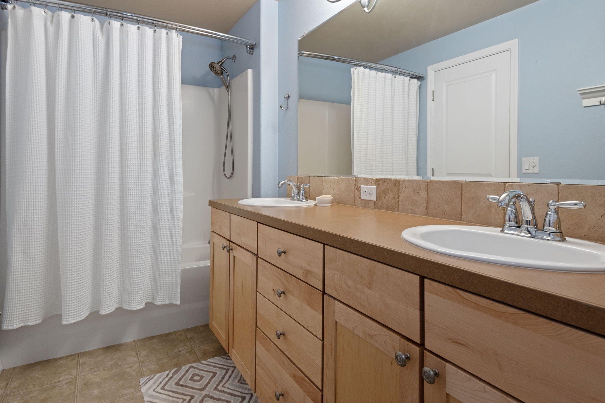 720 North Hindeman Street Sisters, OR 97759 - Photo 14 of 25 a bathroom with a double vanity sink and a mirror