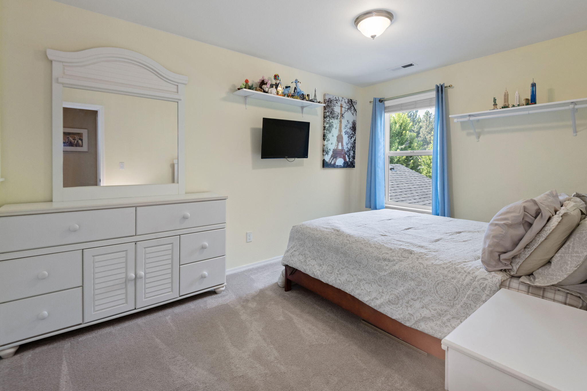 720 North Hindeman Street Sisters, OR 97759 - Photo 15 of 25 a bedroom with a bed and a flat screen tv