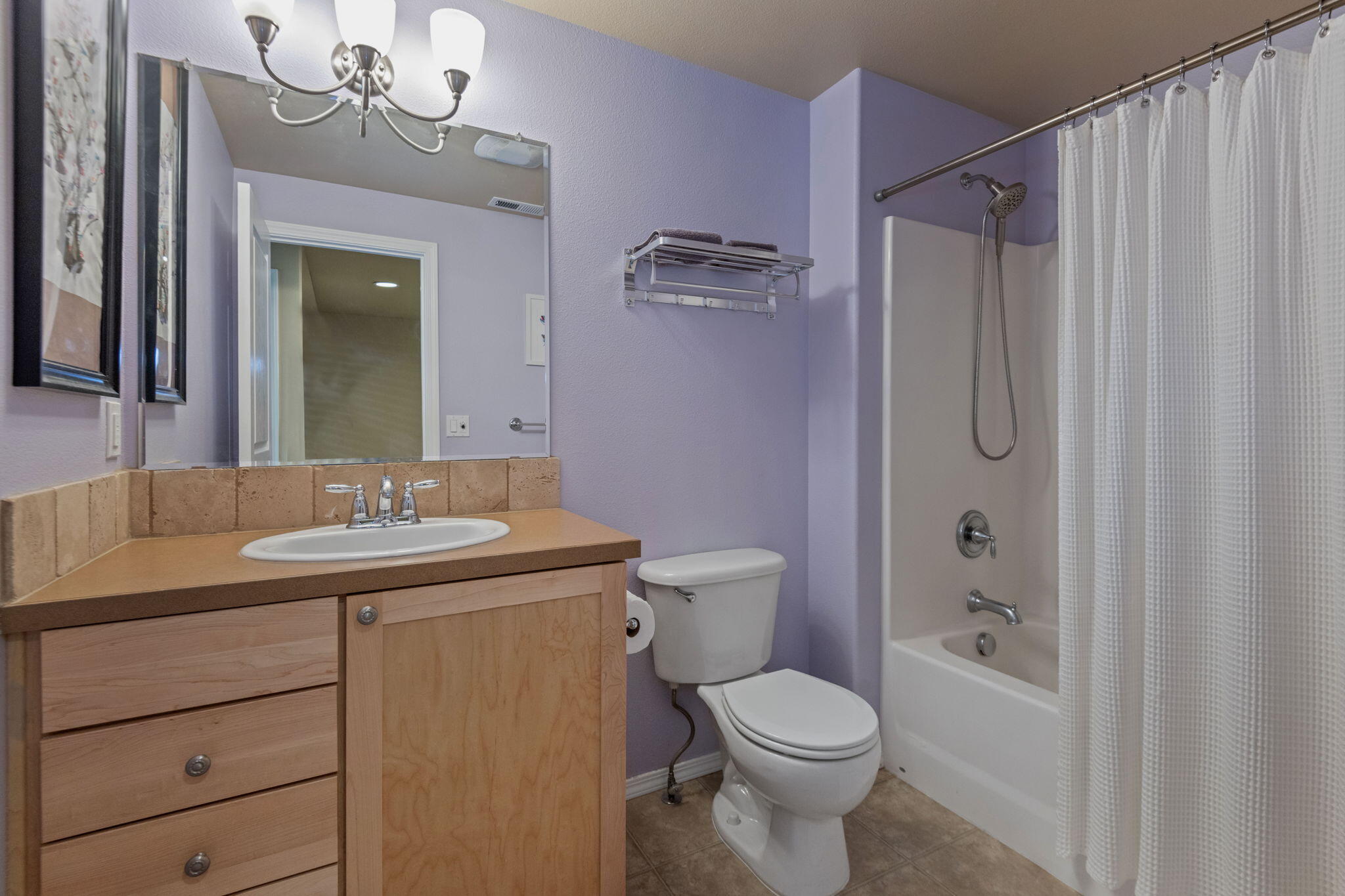 720 North Hindeman Street Sisters, OR 97759 - Photo 18 of 25 a bathroom with a granite countertop sink toilet a mirror a vanity and shower