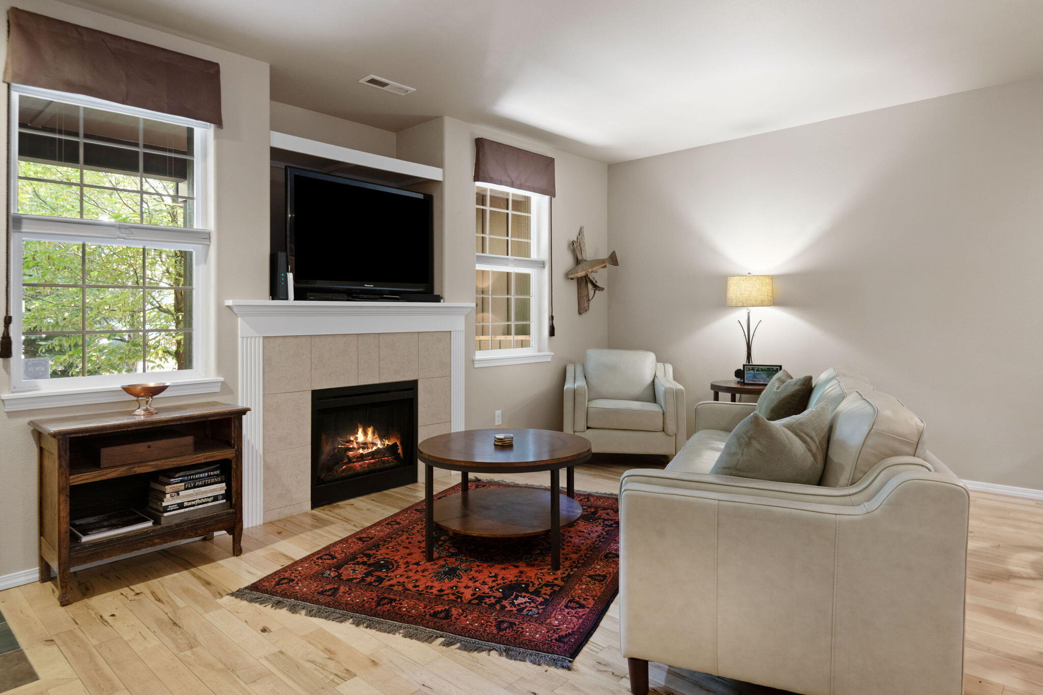 720 North Hindeman Street Sisters, OR 97759 - Photo 2 of 25 a living room with furniture a flat screen tv and a fireplace