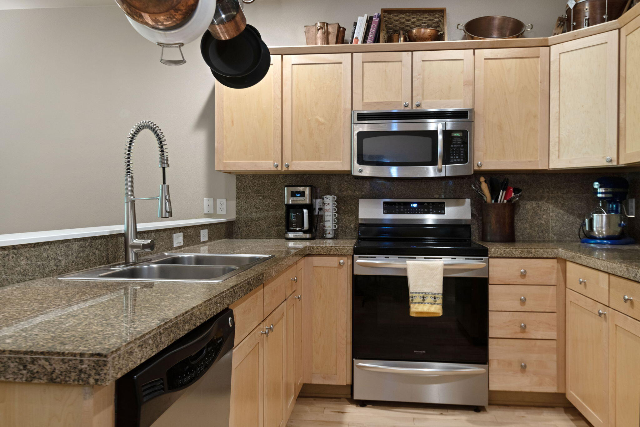 720 North Hindeman Street Sisters, OR 97759 - Photo 6 of 25 a kitchen with stainless steel appliances granite countertop a sink a stove and a microwave