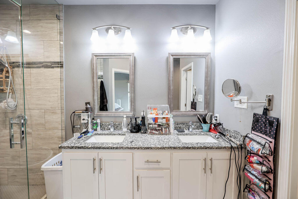 7101 22nd Place Lubbock, TX 79407 - Photo 12 of 24 a bathroom with double vanity sinks and a mirror