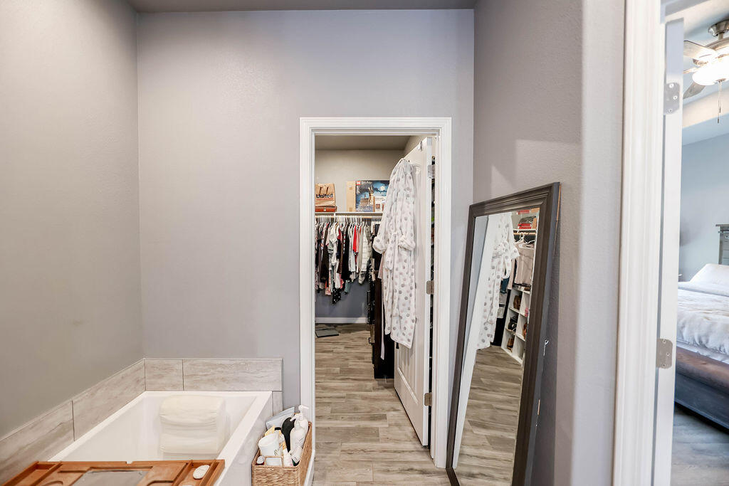 7101 22nd Place Lubbock, TX 79407 - Photo 15 of 24 a view of a hallway with a livingroom and a bathroom with sink