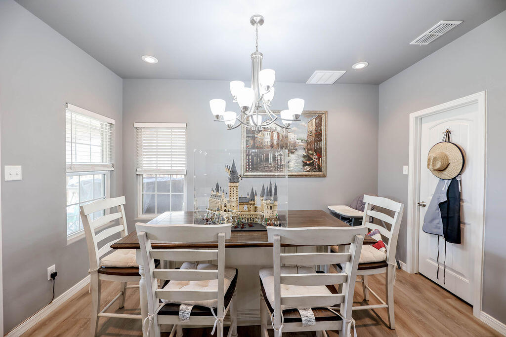 7101 22nd Place Lubbock, TX 79407 - Photo 8 of 24 a view of a dining room with furniture large windows and wooden floor