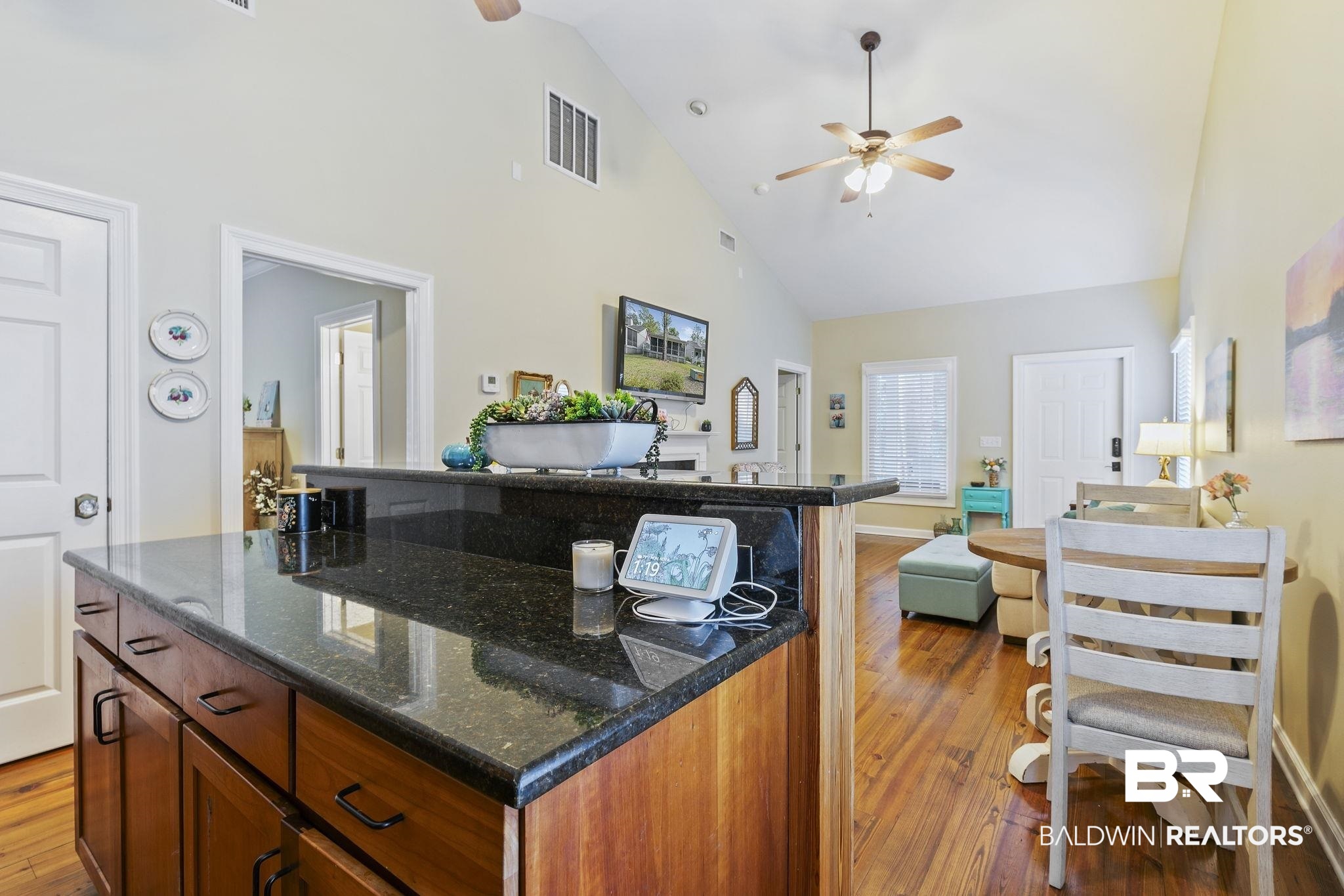 17341 Cabin Road Loxley, AL 36551 - Photo 20 of 49 Kitchen with light hardwood / wood-style floors, dark stone countertops, high vaulted ceiling, and a center island