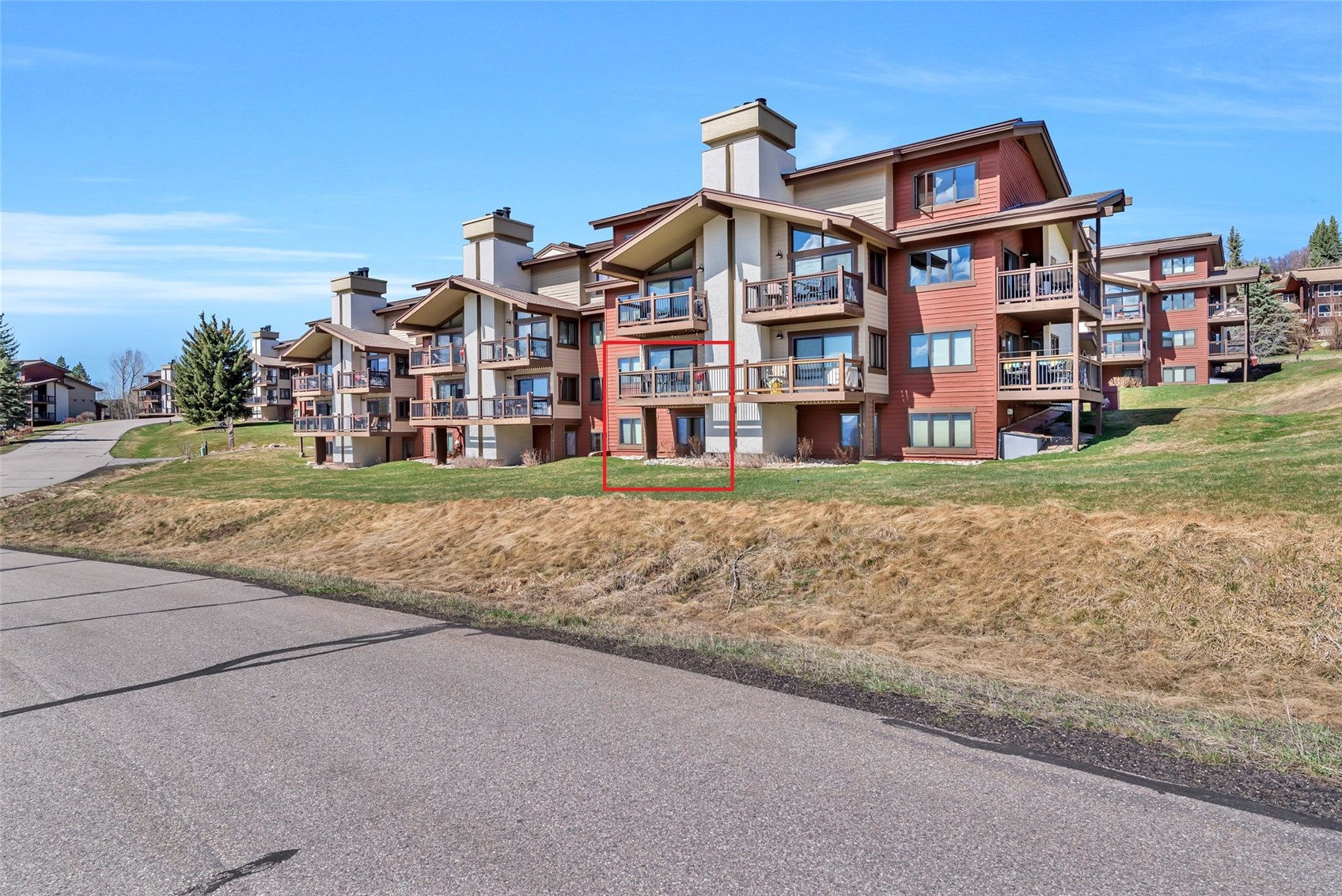 1720 Ranch Road, Unit 309 Steamboat Springs, CO 80487 - Photo 30 of 43 a view of building with a yard