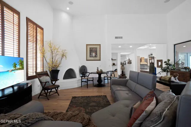 a view of a workspace with furniture and a bookshelf