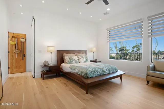 a spacious bathroom with a granite countertop sink and a mirror