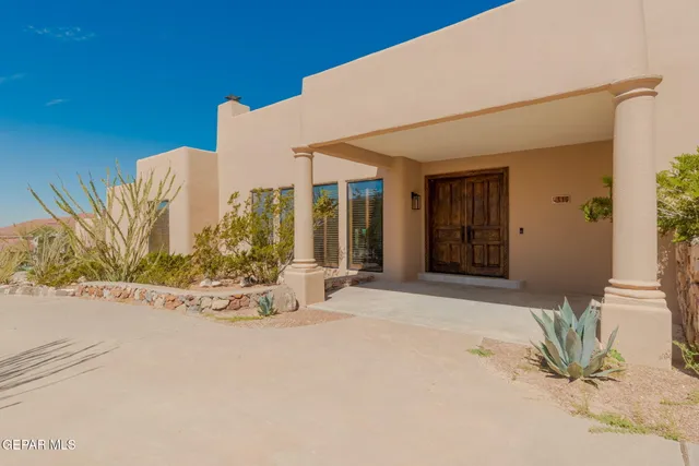 a view of a garden with a building in the background