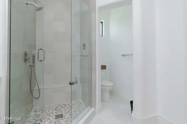 a view of a terrace with lawn chairs