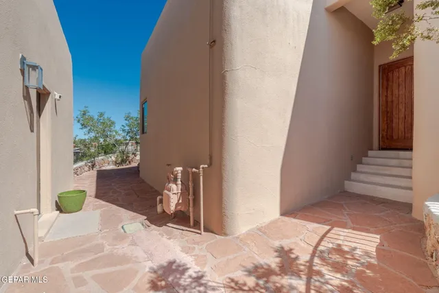 an aerial view of a house with a yard and large trees