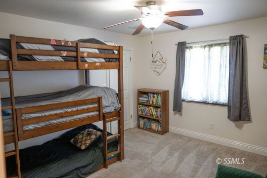 644 Beth Lane Ridgecrest, CA 93555 - Photo 19 of 31 a bedroom with bunk bed and a window