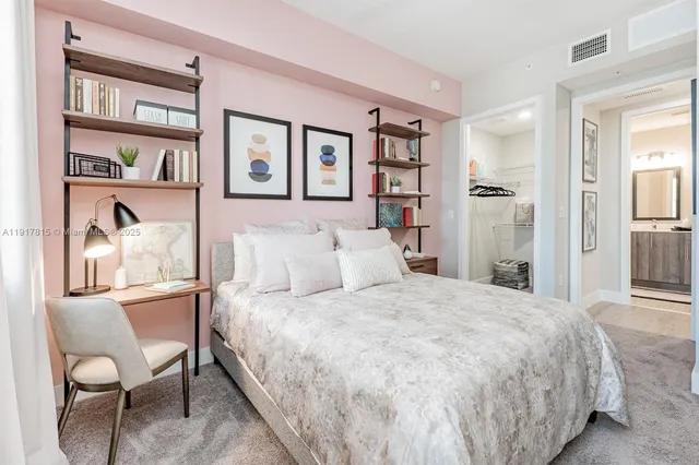 a bedroom with a bed and a painting on the wall