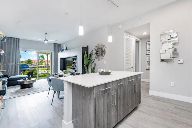 a large kitchen with a table and chairs