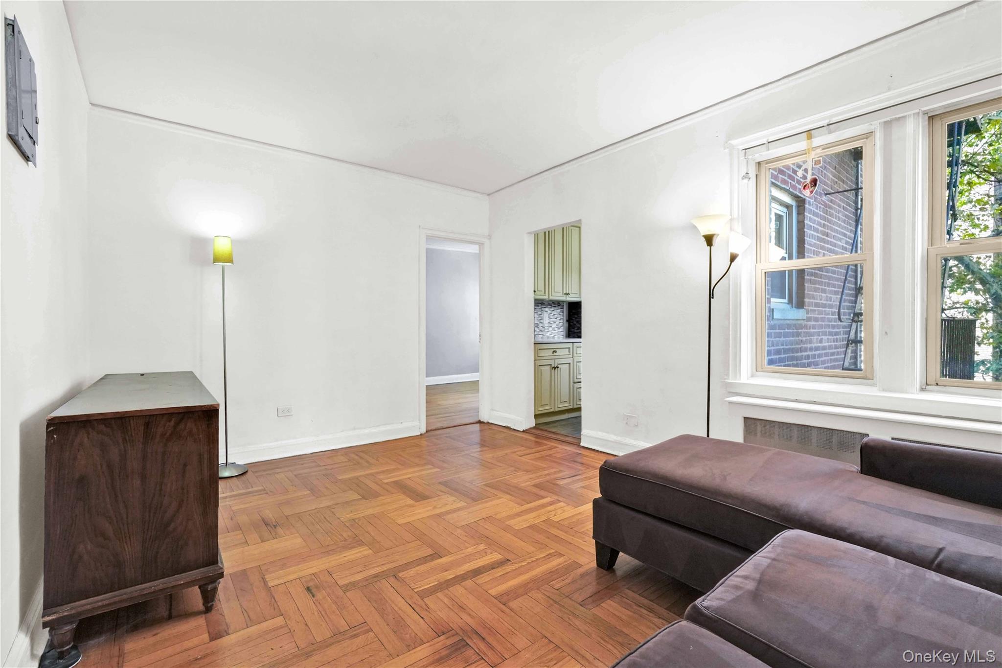 48-50 44th Street, Unit 4E Queens, NY 11377 - Photo 5 of 13 a living room with furniture and a large window