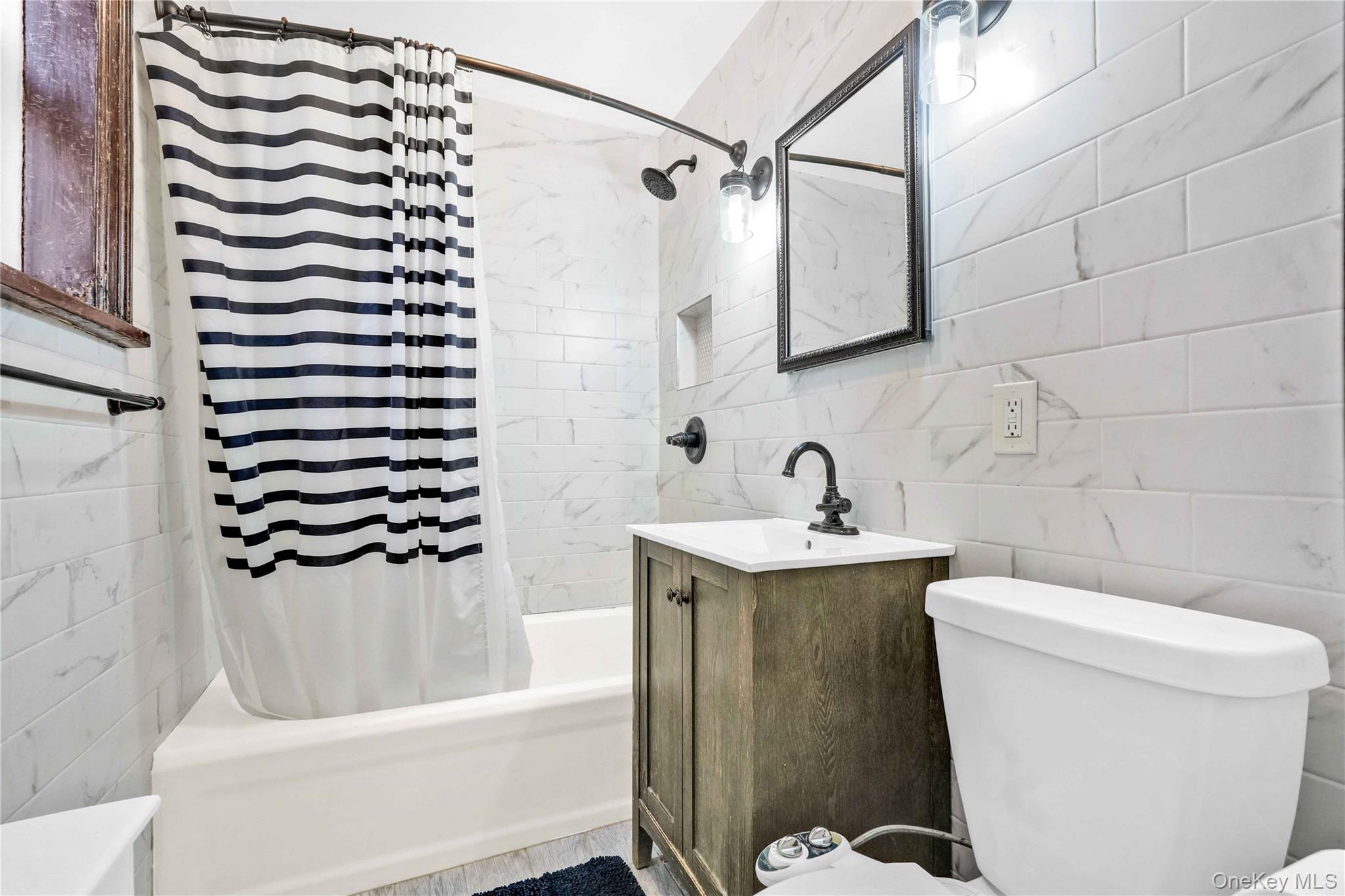 48-50 44th Street, Unit 4E Queens, NY 11377 - Photo 10 of 13 a bathroom with a sink toilet and shower