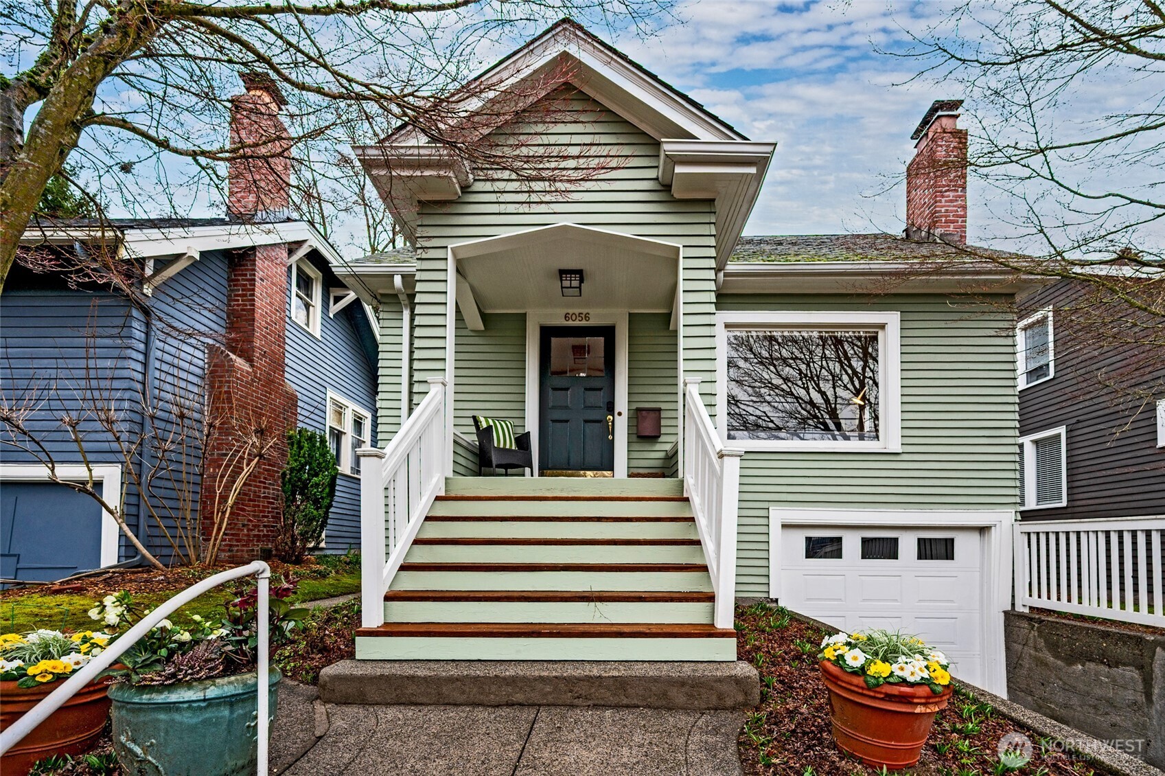 6056 25th Avenue Northeast Seattle, WA 98115 - Photo 1 of 34 a front view of a house with a garden