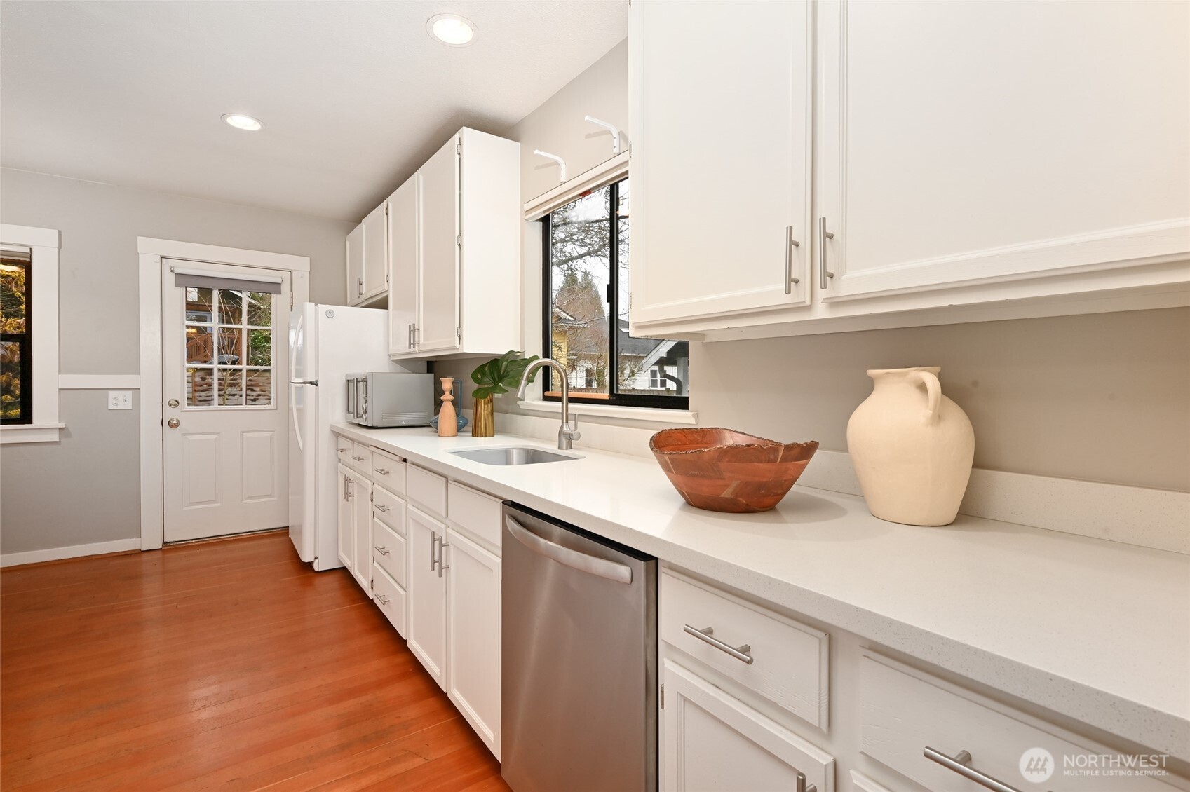6056 25th Avenue Northeast Seattle, WA 98115 - Photo 11 of 34 a kitchen with stainless steel appliances a sink and a window