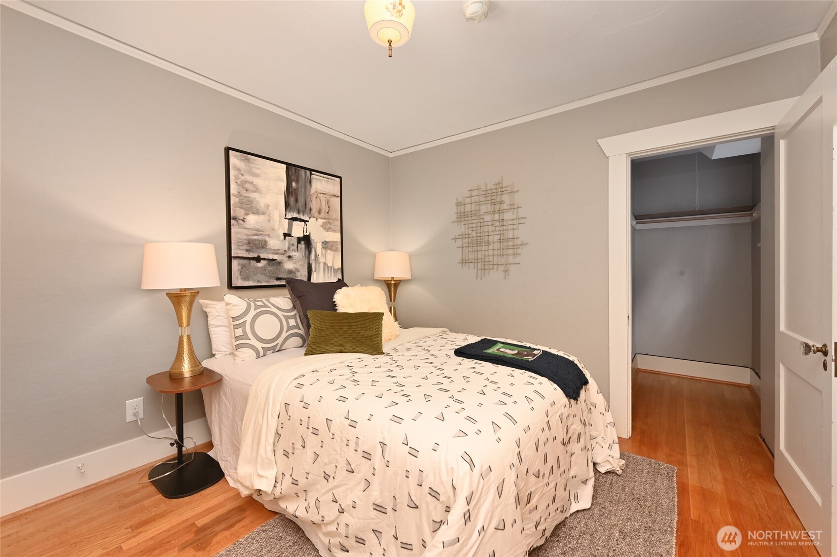 6056 25th Avenue Northeast Seattle, WA 98115 - Photo 14 of 34 a bedroom with a bed and wooden floor