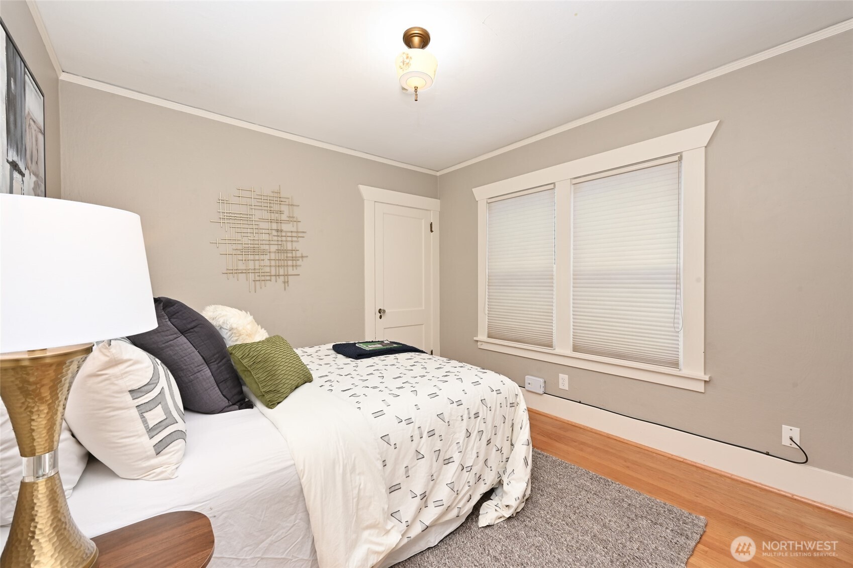 6056 25th Avenue Northeast Seattle, WA 98115 - Photo 15 of 34 a bedroom with a bed and a window