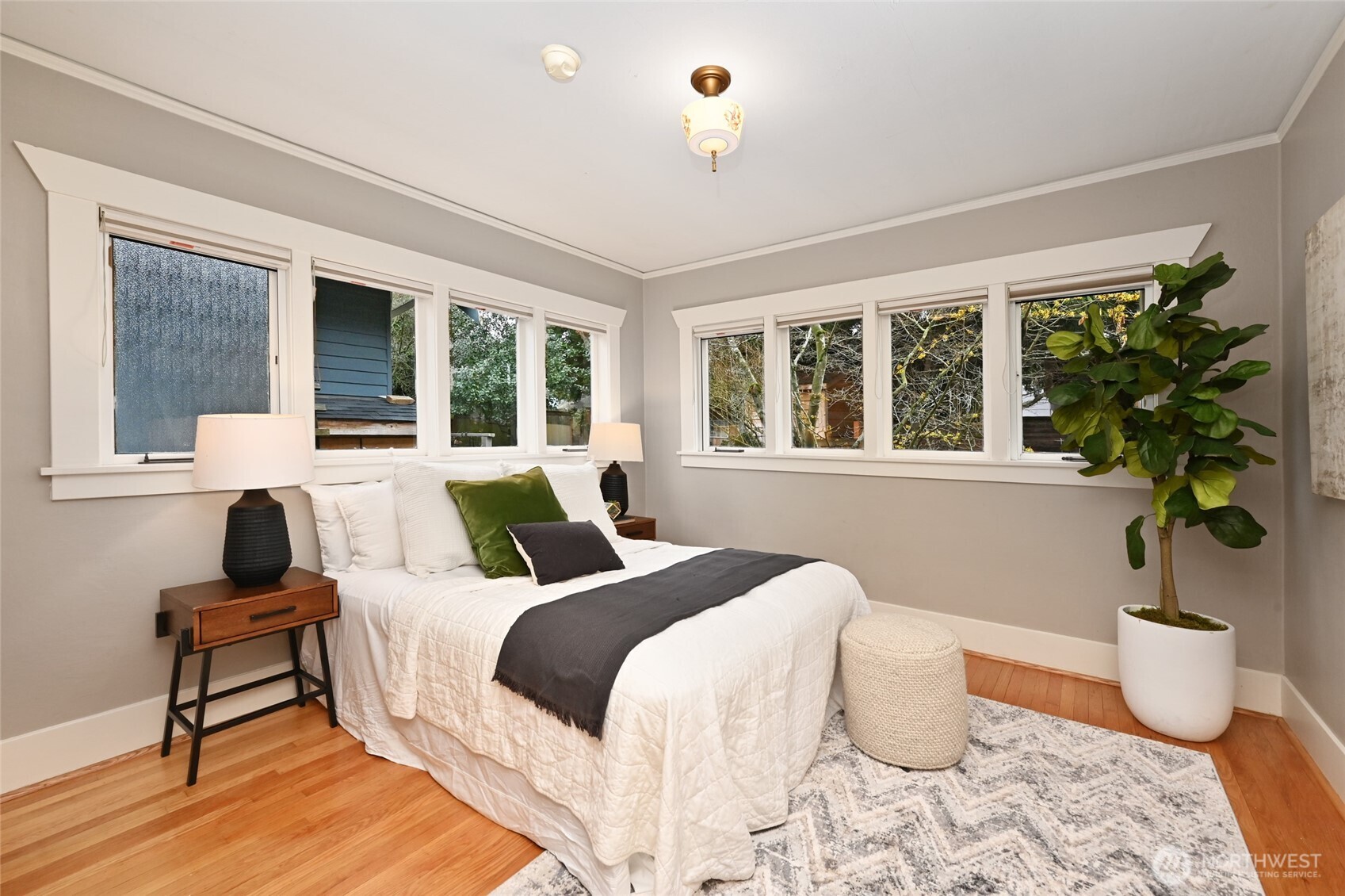 6056 25th Avenue Northeast Seattle, WA 98115 - Photo 16 of 34 a bedroom with a bed and a potted plant