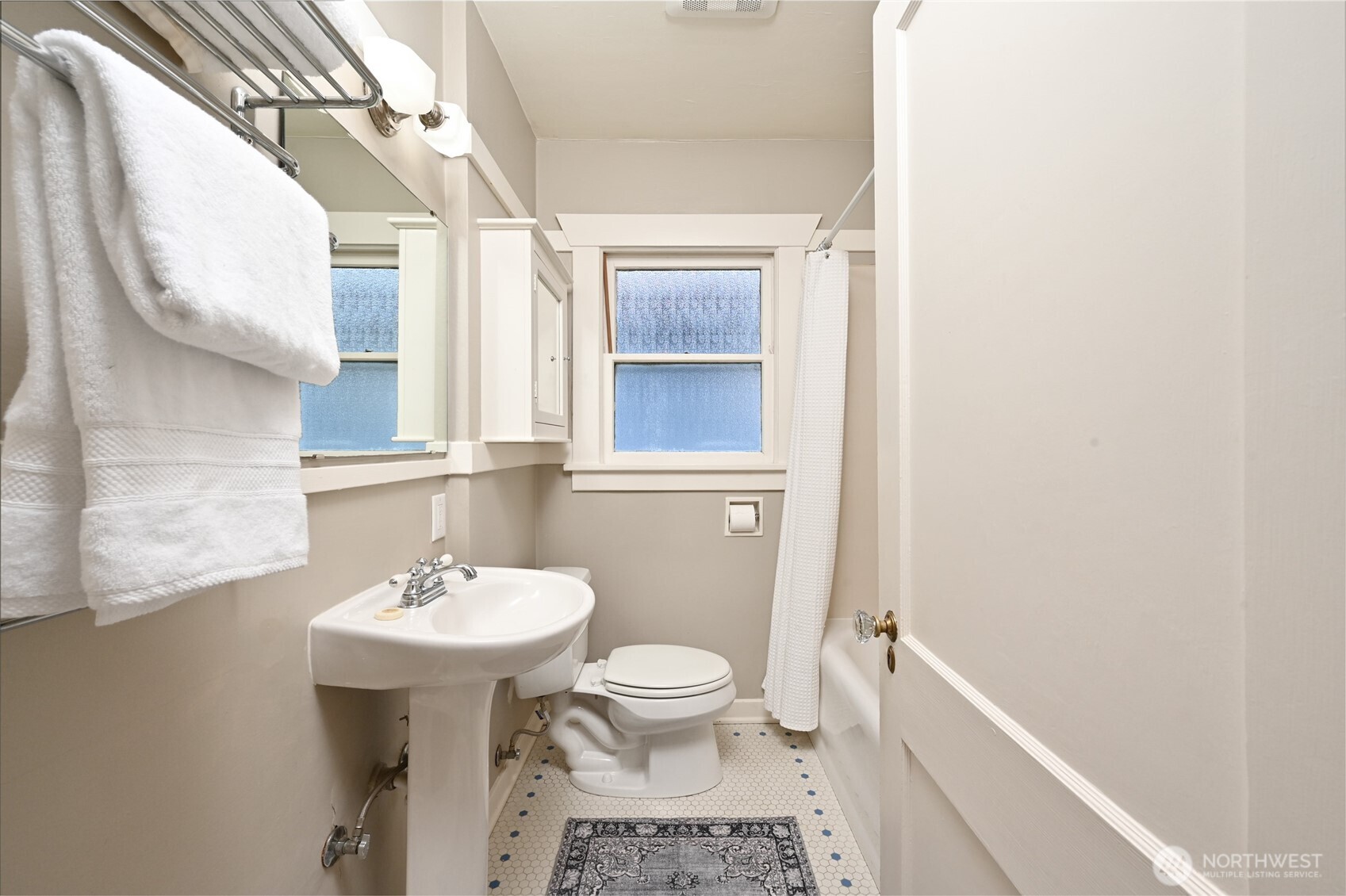 6056 25th Avenue Northeast Seattle, WA 98115 - Photo 17 of 34 a bathroom with a sink a toilet and mirror