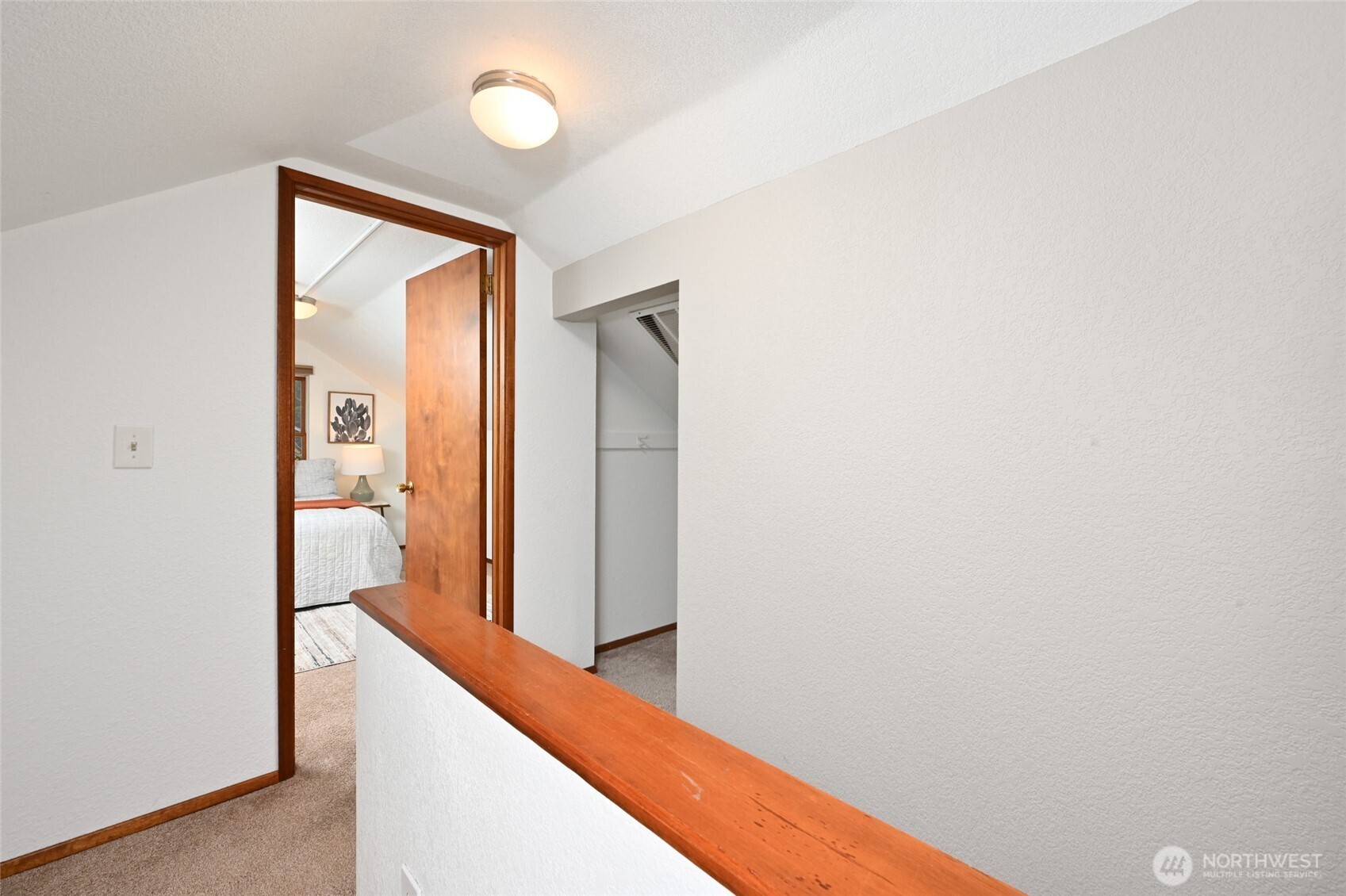 6056 25th Avenue Northeast Seattle, WA 98115 - Photo 18 of 34 a view of hallway with bathroom and wooden floor