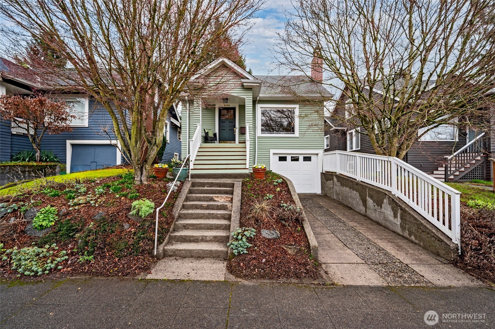 6056 25th Avenue Northeast Seattle, WA 98115 - Photo 2 of 34 a front view of a house with a yard