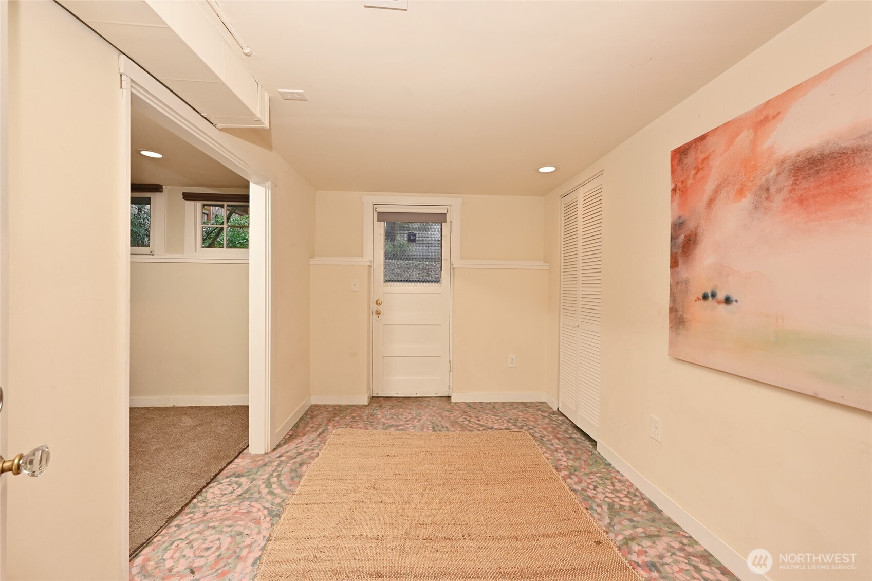 6056 25th Avenue Northeast Seattle, WA 98115 - Photo 25 of 34 a view of a hallway with wooden floor and a bathroom