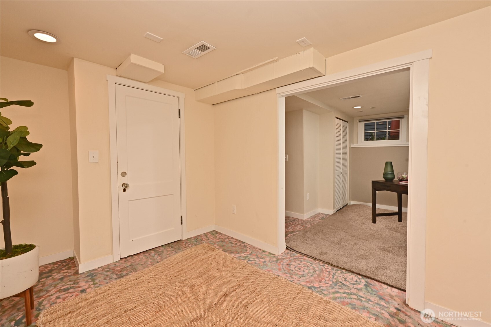 6056 25th Avenue Northeast Seattle, WA 98115 - Photo 26 of 34 a view of a hallway to a room with wooden floor and a bathroom