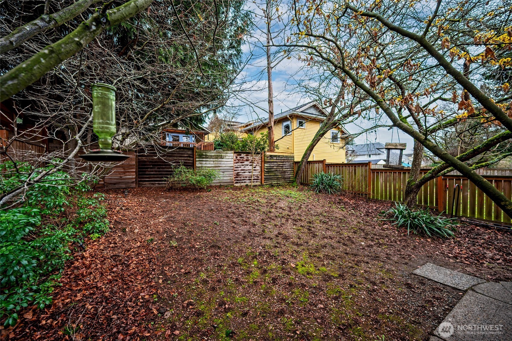 6056 25th Avenue Northeast Seattle, WA 98115 - Photo 33 of 34 a backyard of a house with lots of green space