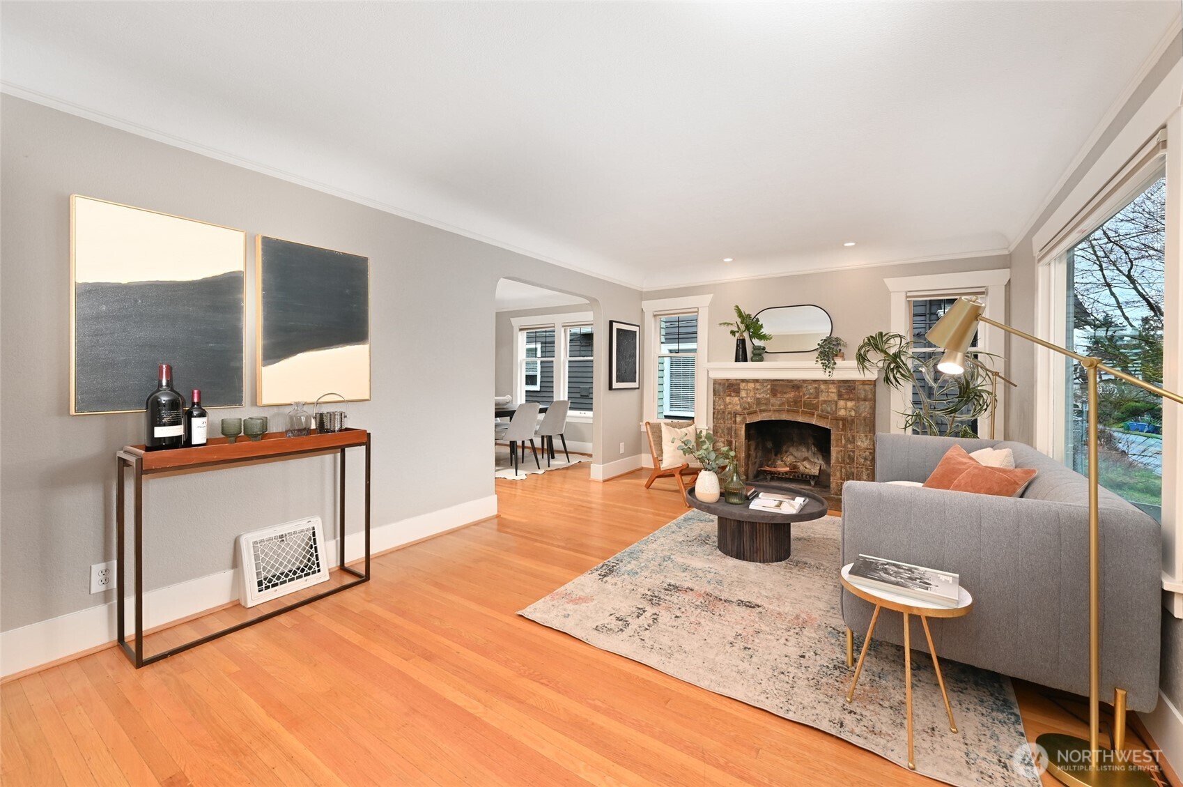 6056 25th Avenue Northeast Seattle, WA 98115 - Photo 6 of 34 a living room with furniture a fireplace and a large window
