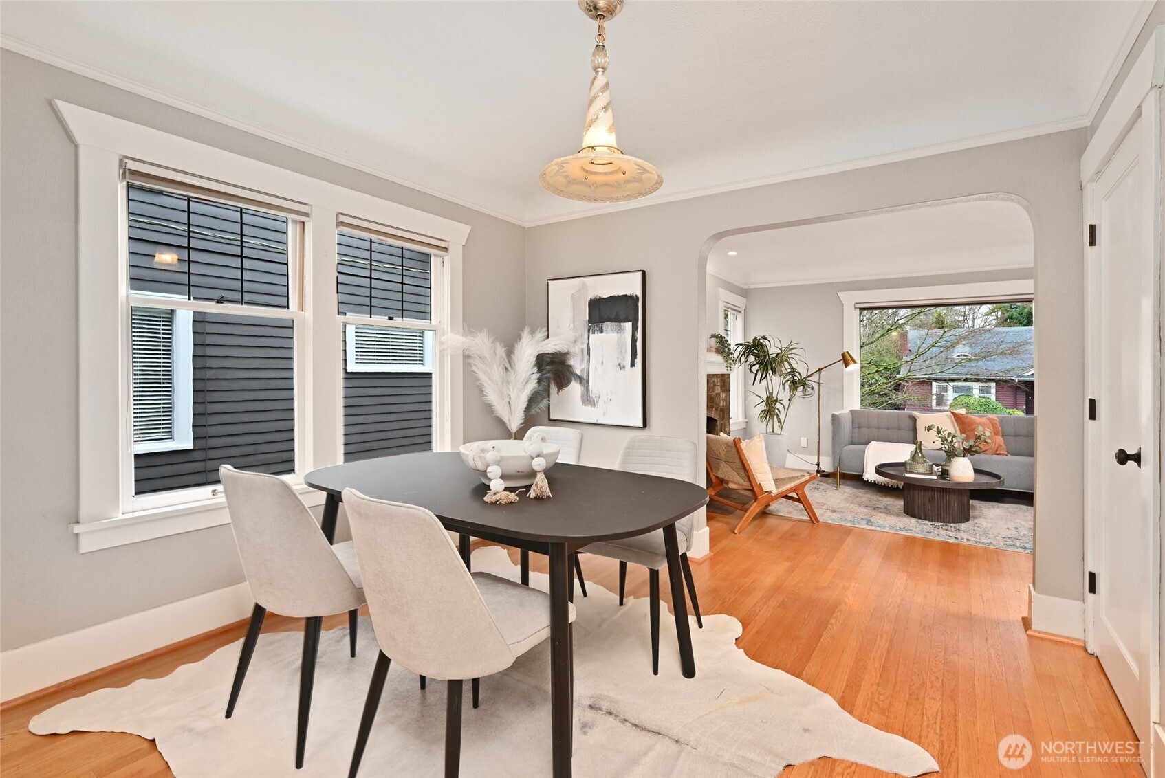 6056 25th Avenue Northeast Seattle, WA 98115 - Photo 9 of 34 a view of a livingroom and dining room with furniture wooden floor and a chandelier
