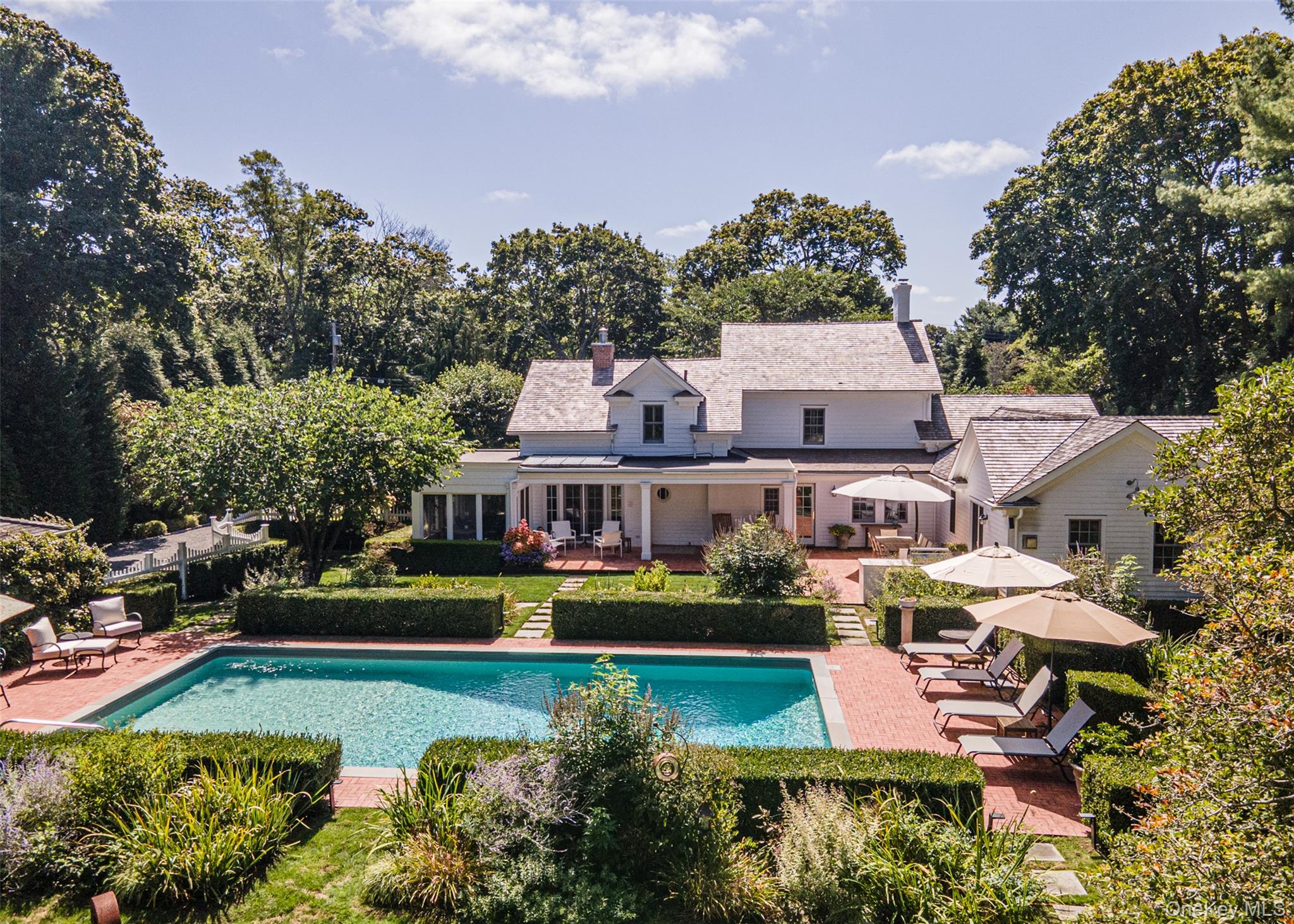 92 South Country Road Remsenburg, NY 11960 - Photo 1 of 1 an aerial view of a house with a garden and lake view