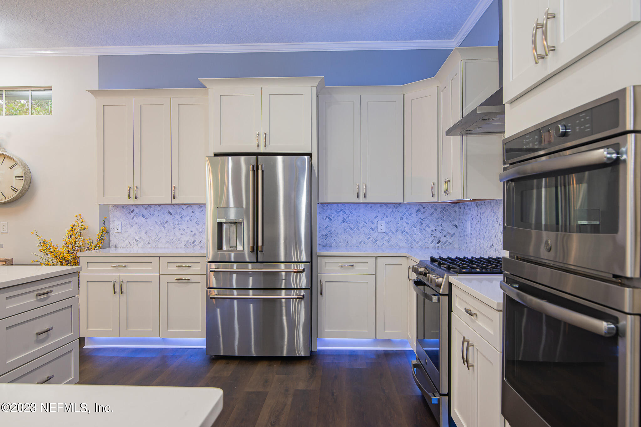 780 Queens Harbor Boulevard Jacksonville, FL 32225 - Photo 11 of 42 a kitchen with granite countertop a refrigerator stove and wooden cabinets