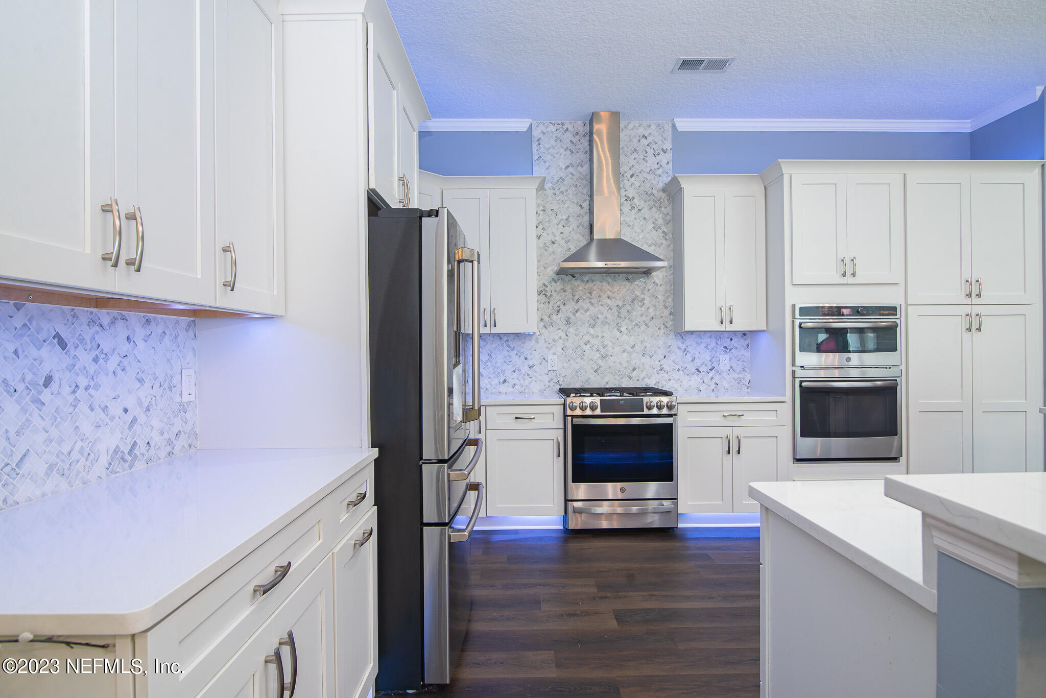 780 Queens Harbor Boulevard Jacksonville, FL 32225 - Photo 15 of 42 a kitchen with granite countertop white cabinets and stainless steel appliances