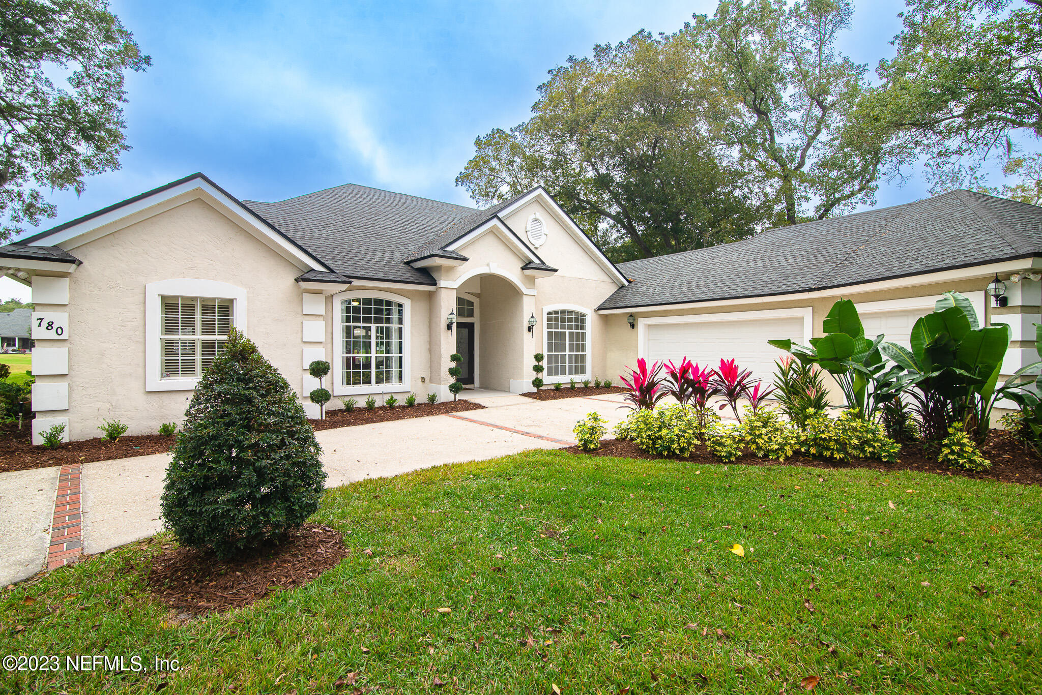 780 Queens Harbor Boulevard Jacksonville, FL 32225 - Photo 2 of 42 a front view of a house with a garden
