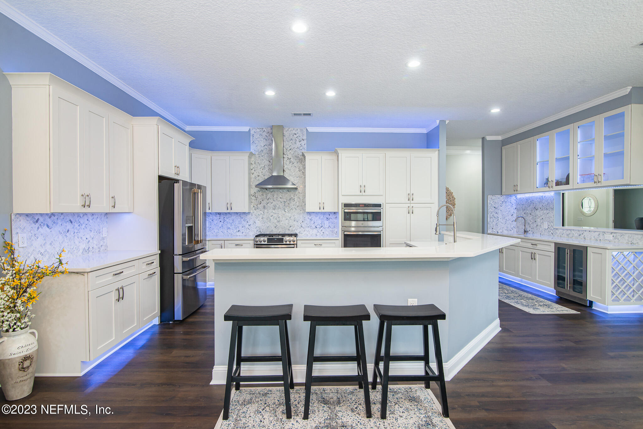 780 Queens Harbor Boulevard Jacksonville, FL 32225 - Photo 21 of 42 a kitchen with stainless steel appliances granite countertop a table chairs sink and cabinets