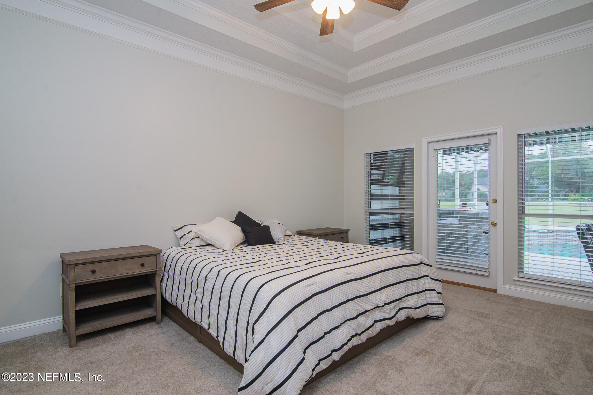 780 Queens Harbor Boulevard Jacksonville, FL 32225 - Photo 29 of 42 a bedroom with a bed and a chandelier
